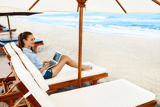 istock Business Woman Working Online On Beach. Freelance Computer Internet Job 600062922