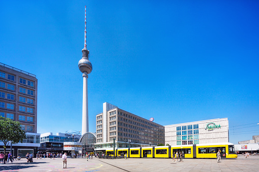 View of Alexanderplatz with yellow tram in Mitte Berlin Germany