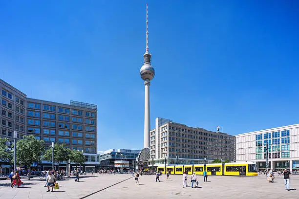 View of Alexanderplatz with yellow tram in Mitte Berlin Germany
