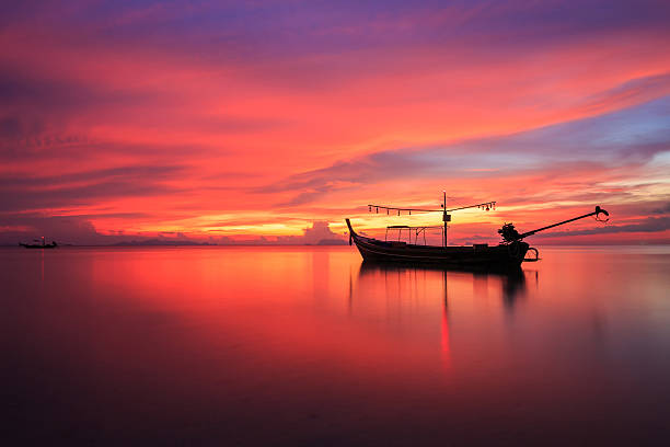 istock Silhouette traditional longtail boat and beautiful red sky 600063660