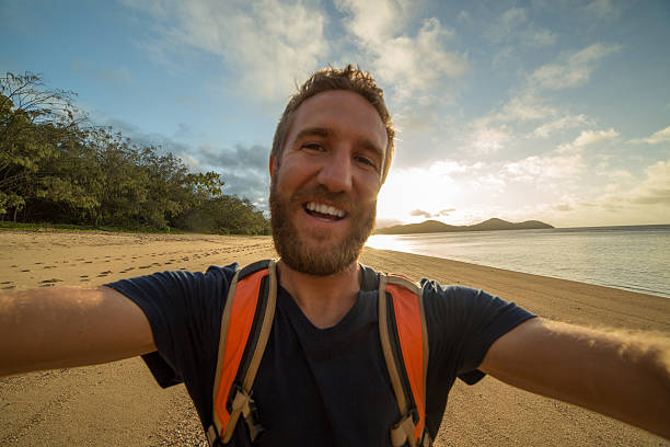 istock Young man takes selfie on beach 600064814