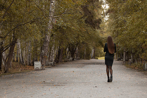 istock Young girl walking in autumn park 600067922