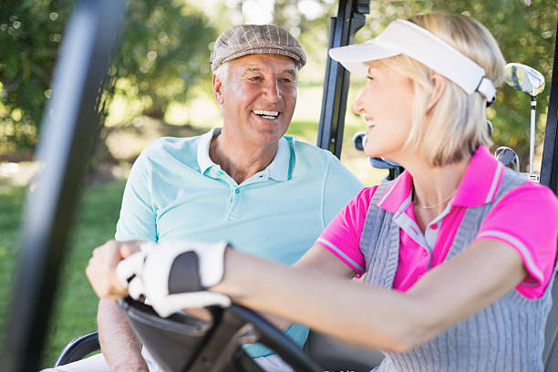 istock Confident couple sitting in golf buggy 600068518