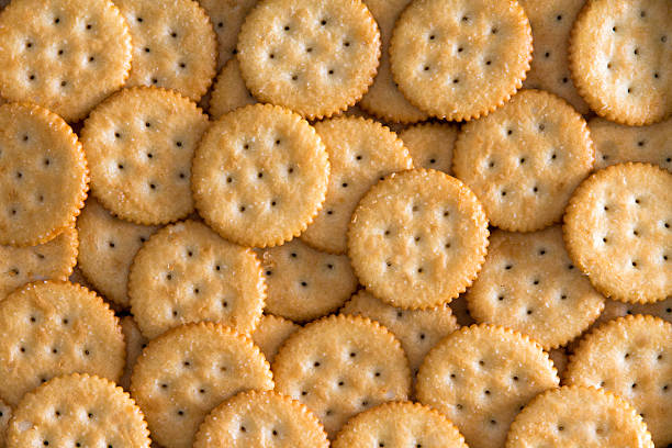 Salted Baked Round Crackers for Backgrounds Close up Plenty Salted Toasted Round Crackers for Backgrounds, Captured in High Angle View. savory stock pictures, royalty-free photos & images
