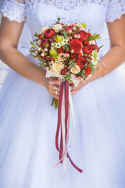 istock Bride in White Dress Holding Splendid Bridal Boquet 600070172