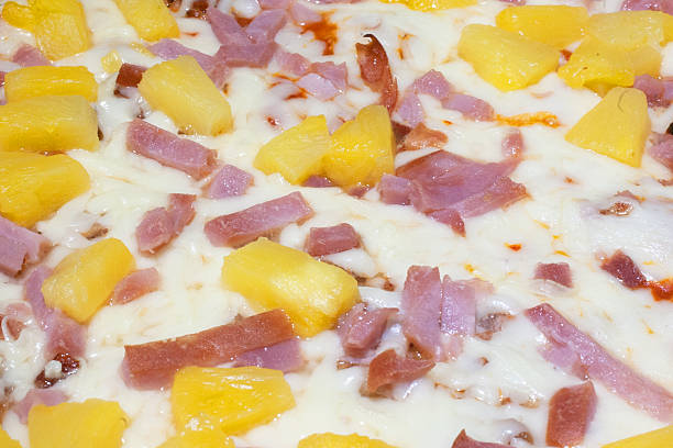istock Hawaiian pizza full frame macro fast food background 600071460