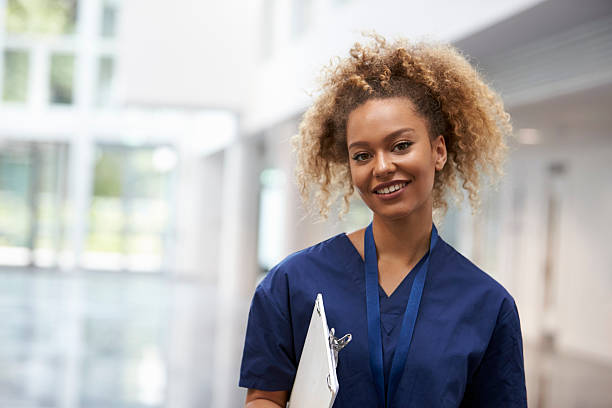 portrait of female nurse wearing scrubs in hospital - smiling nurse bildbanksfoton och bilder