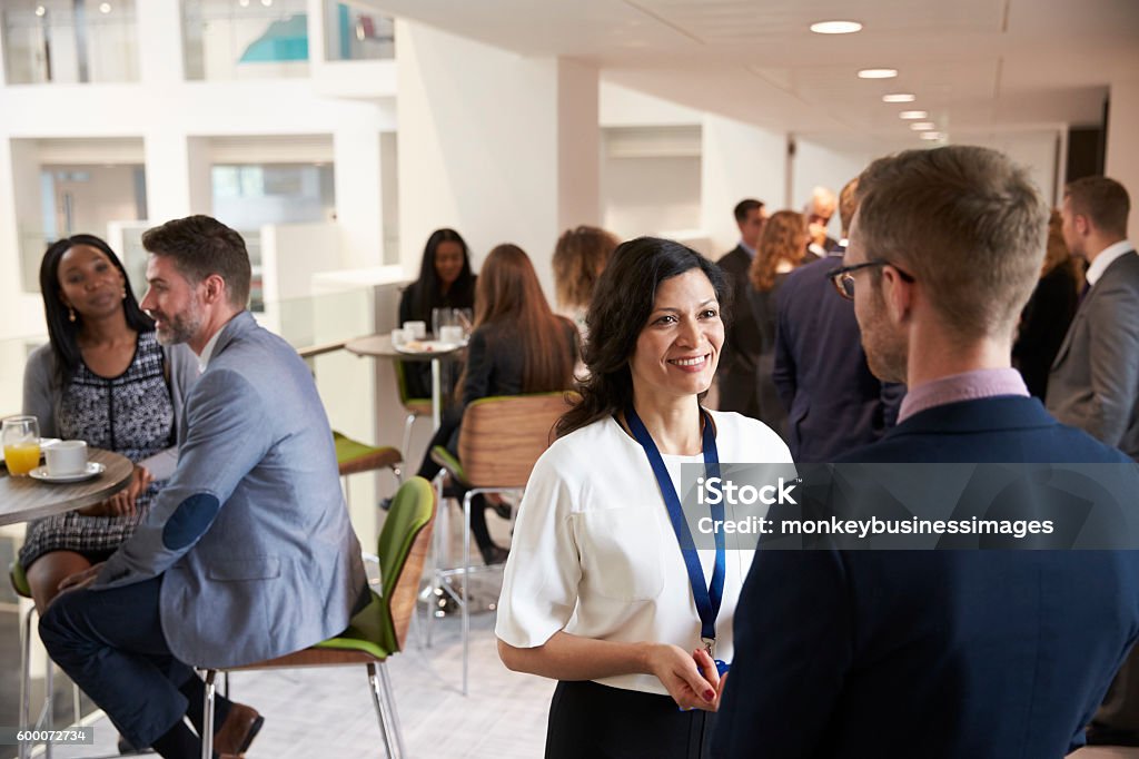 Delegates Networking During Coffee Break At Conference Meeting Stock Photo