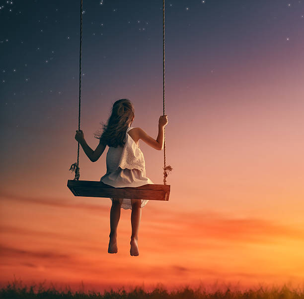 istock child girl on swing 600073322