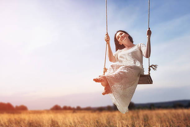 istock young woman on a swing 600073578