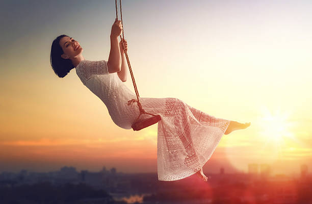 istock young woman on a swing 600073738