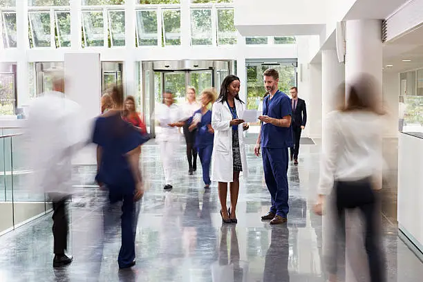Photo of Staff In Busy Lobby Area Of Modern Hospital