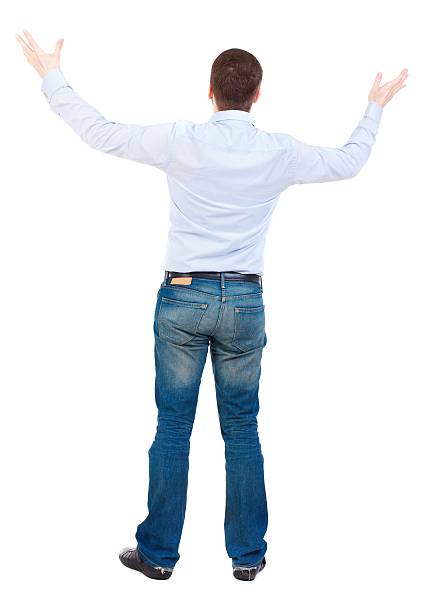 istock man in a jacket raised his hands in praye 600082718