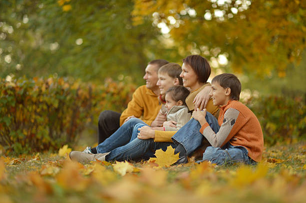 istock Family relaxing in autumn park 600083018