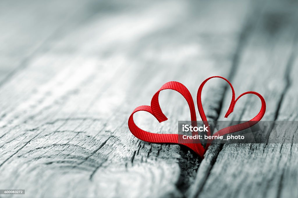 Valentines Day background Red ribbon in heart shape at wooden background Valentine's Day - Holiday Stock Photo