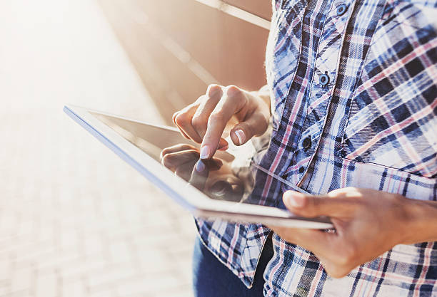 istock Girl using digital tablet outdoors 600088716