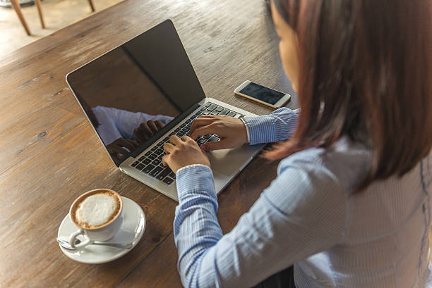 istock Woman working with laptop and hot cappuccino 600088886