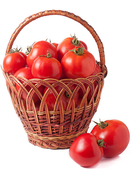 istock red tomatoes in a wicker basket isolated on white background 600089738
