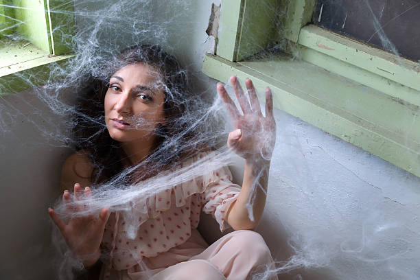 Woman caught in spiderweb stock photo
