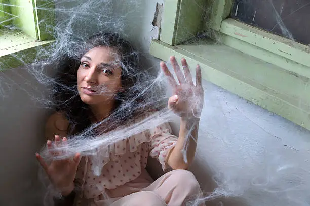 Photo of Woman caught in spiderweb