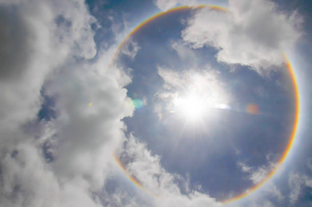 sun halo occurring due to ice crystal sun halo occurring due to ice crystals in atmosphere in thai sundog stock pictures, royalty-free photos & images