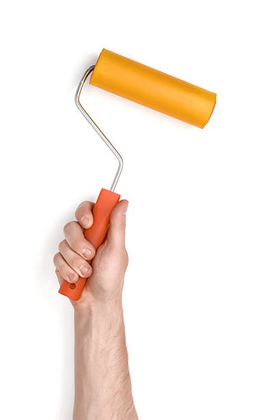 istock Close-up view of man's hand with paint roller 600092226