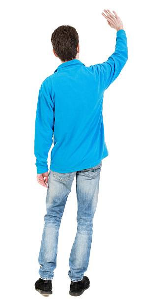 istock Back view of handsome man greeting waving from his hands 600092268