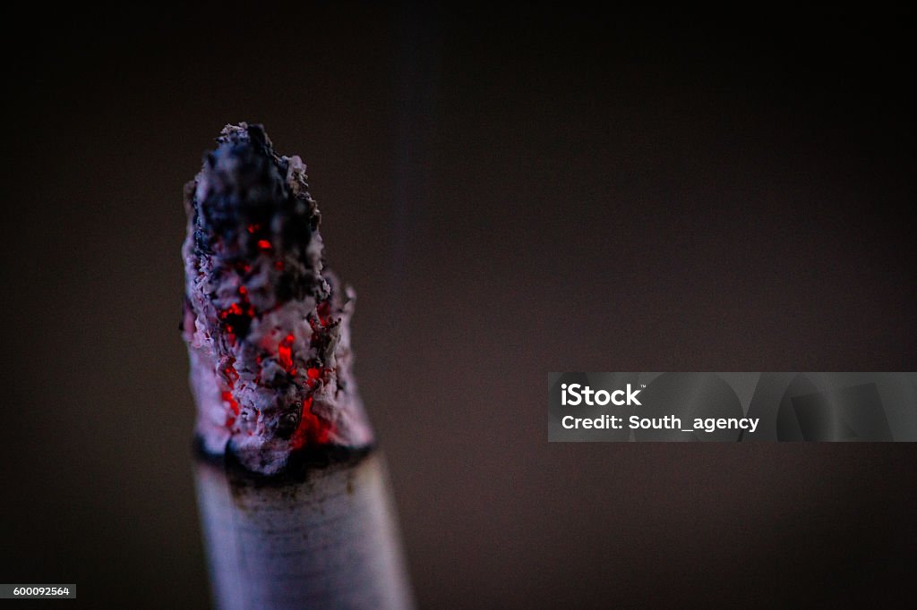 Burning cigarette Burning cigarette close-up on a black background Cigarette Stock Photo