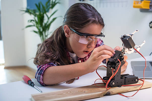 Learning robotics basics Young student learning about robotics. career girl stock pictures, royalty-free photos & images