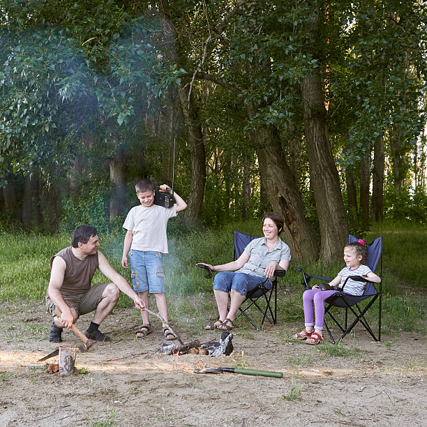 istock people camping in forest, family active in nature, kindle fire 600095234