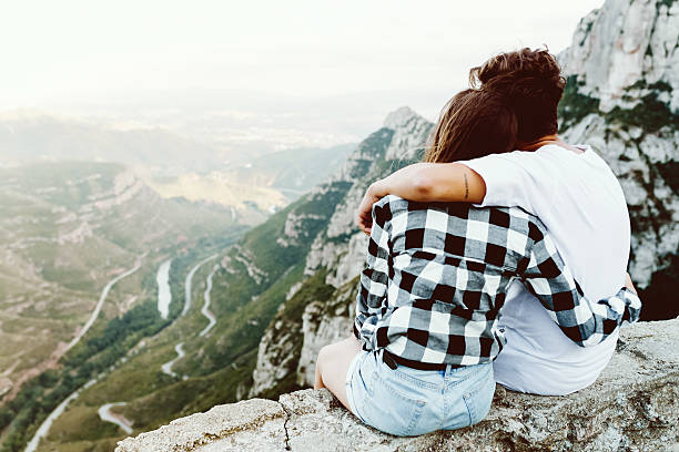 istock Beautiful young couple enjoying nature at mountain peak. 600095778