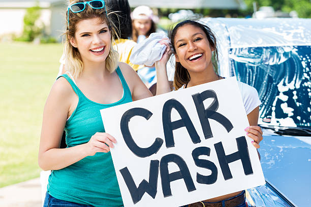 istock Diverse teenagers enjoy fundraising car wash 600096020