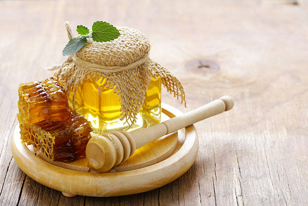 istock natural organic honey, honeycombs on a wooden table 600096260