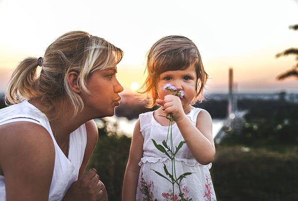 istock Mother and daughter outdoors in a meadow. 600097236