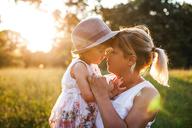 istock Mother and daughter outdoors in a meadow. 600097310