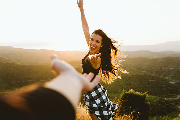 istock Beautiful young couple enjoying nature at mountain peak. 600097334