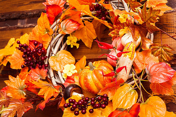 istock Woven wreath decorated orange leaves, autumn vegetables 600099204