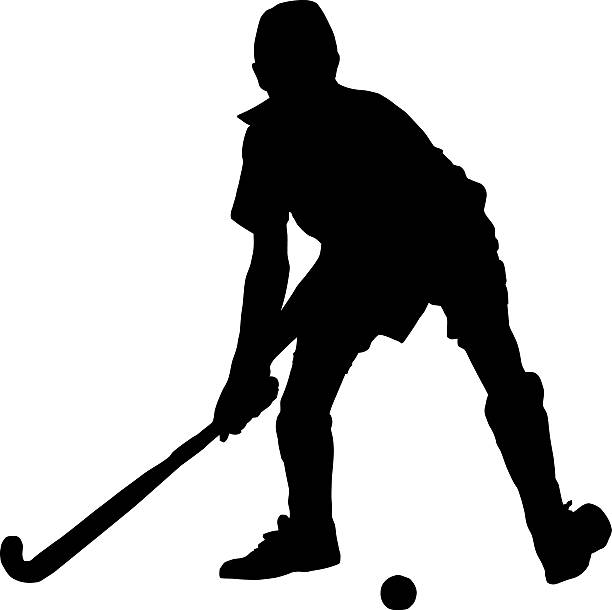 istock Silhouette of boy hockey player hitting ball 600099478