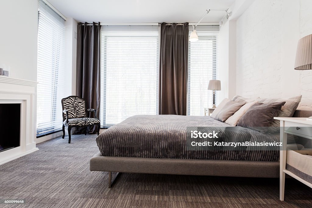 Sanctuary for sleep and relaxation Shot of a modern bedroom with a king-size bed and big windows Bed - Furniture Stock Photo