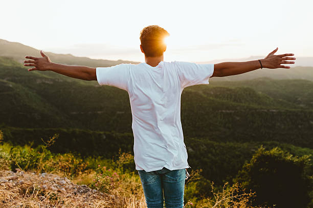 istock Handsome young man enjoying nature at mountain peak. 600099772