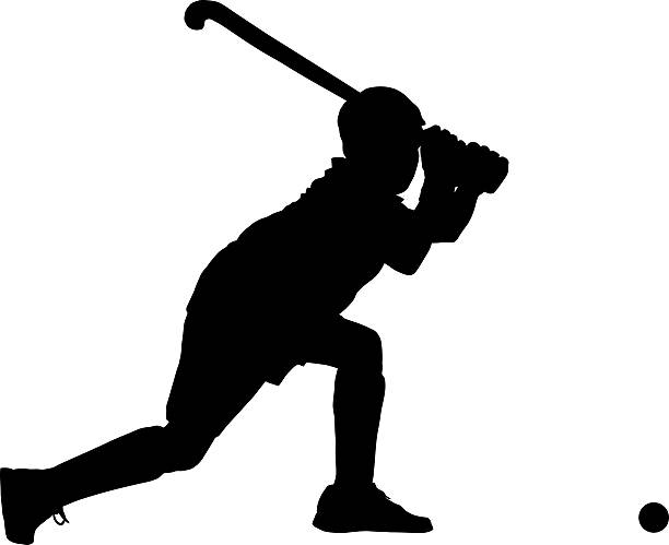 istock Silhouette of boy hockey player hitting ball 600100206