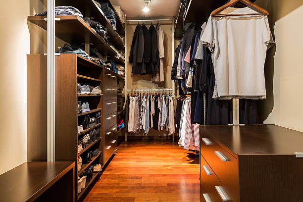 Kingdom of fashion Shot of a walk-in closet full of clothes walk in closet stock pictures, royalty-free photos & images