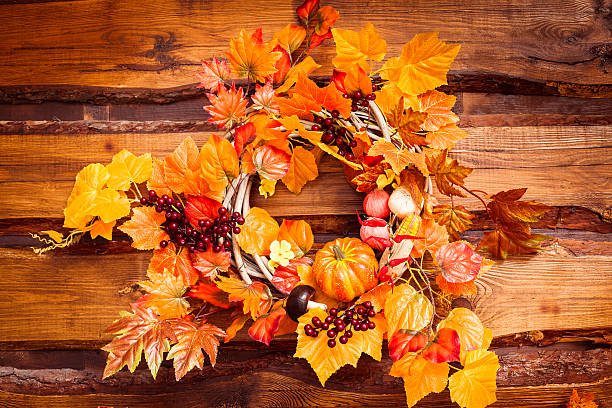 istock Woven wreath decorated orange leaves, autumn vegetables 600101740