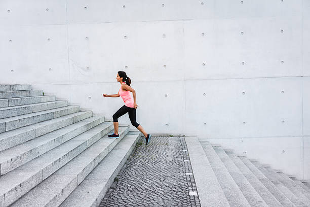 istock Woman running up steps in urban setting 600102386