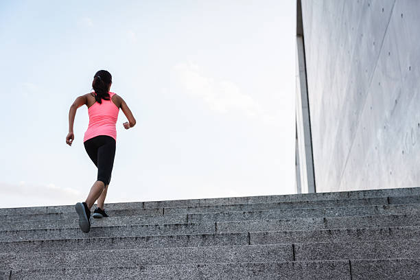 istock Woman running up steps in urban setting 600102466