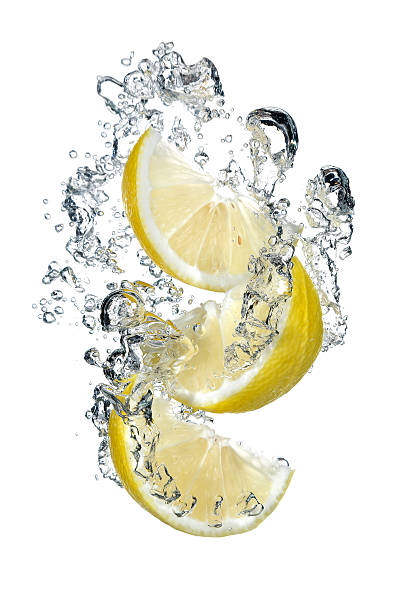 istock Three slices of lemon falling into water 600132082