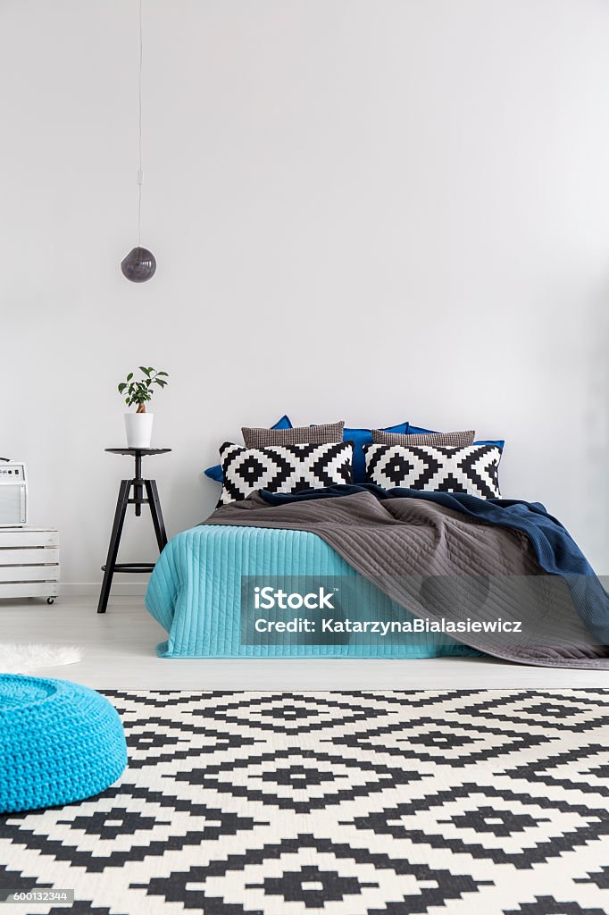 Simplicity in design Shot of a bed in a modern spacious bedroom Apartment Stock Photo