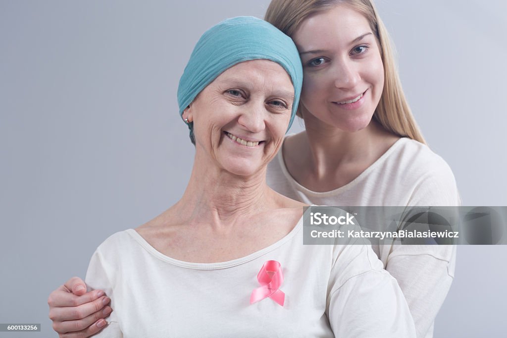 Staying together in tough disease Young daughter and her mother with breast cancer staying together Adult Stock Photo