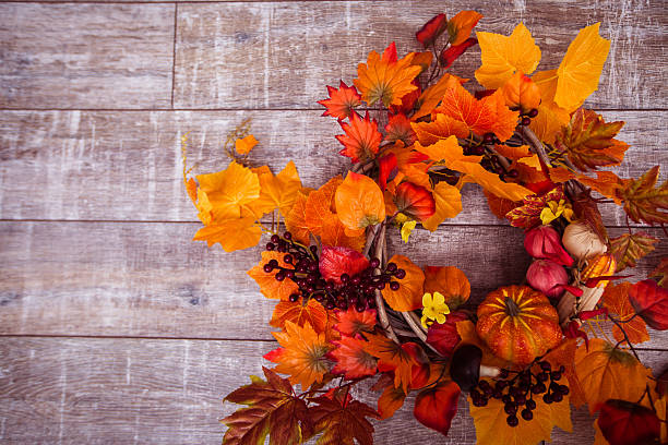 istock Woven wreath decorated orange leaves, autumn vegetables 600134398