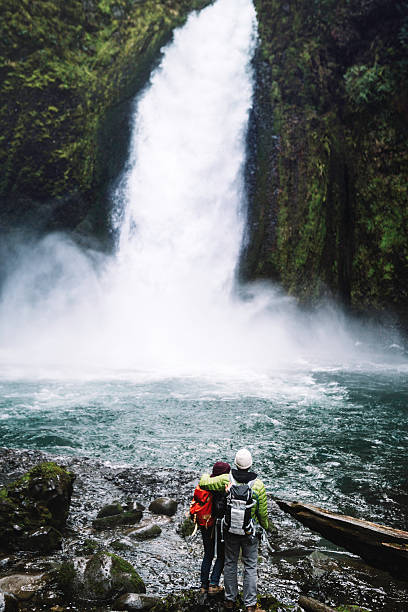 istock Couple Hiking by Waterfall 600135010